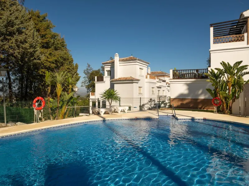 Townhouse for sale in Lauro Golf one of the most prestigious golf courses in Malaga. The property is distributed over three floors. On the ground floor there is a fully equipped kitchen, a toilet, a large living room with a fireplace that leads to a priva