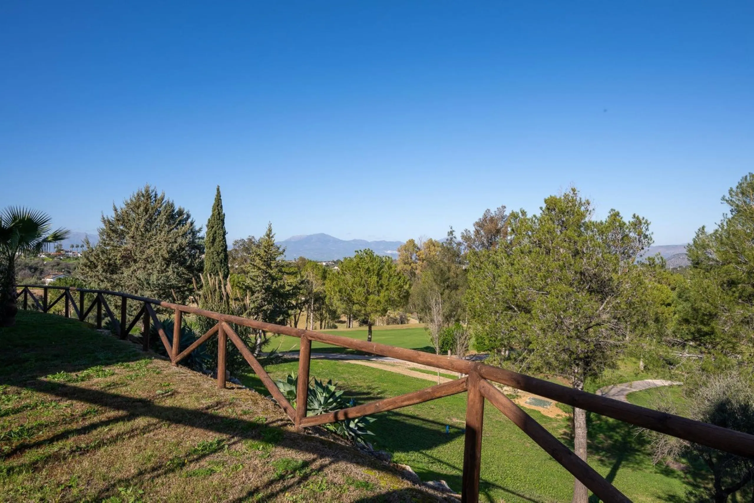 Townhouse for sale in Lauro Golf one of the most prestigious golf courses in Malaga. The property is distributed over three floors. On the ground floor there is a fully equipped kitchen, a toilet, a large living room with a fireplace that leads to a priva