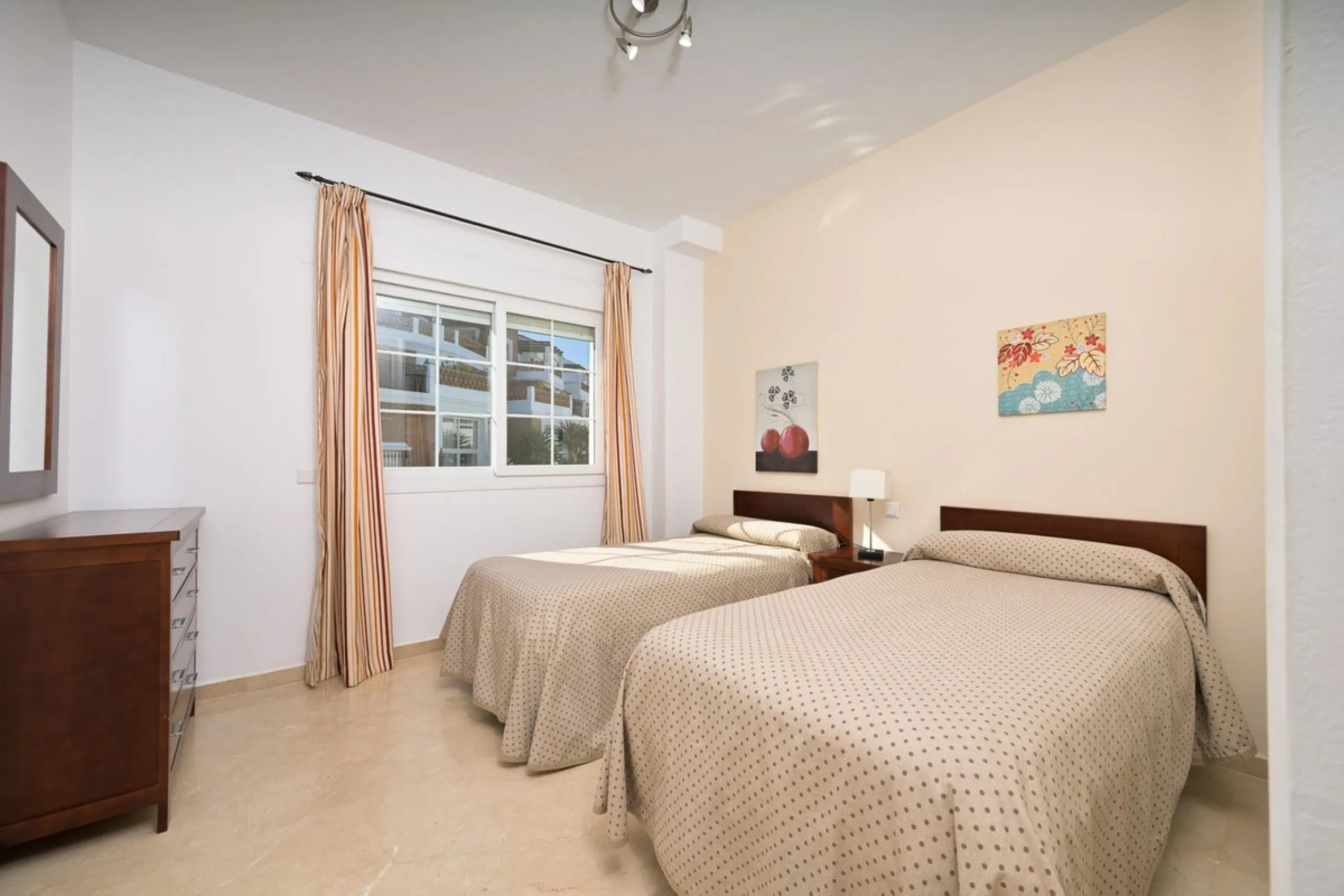Townhouse for sale in Lauro Golf one of the most prestigious golf courses in Malaga. The property is distributed over three floors. On the ground floor there is a fully equipped kitchen, a toilet, a large living room with a fireplace that leads to a priva