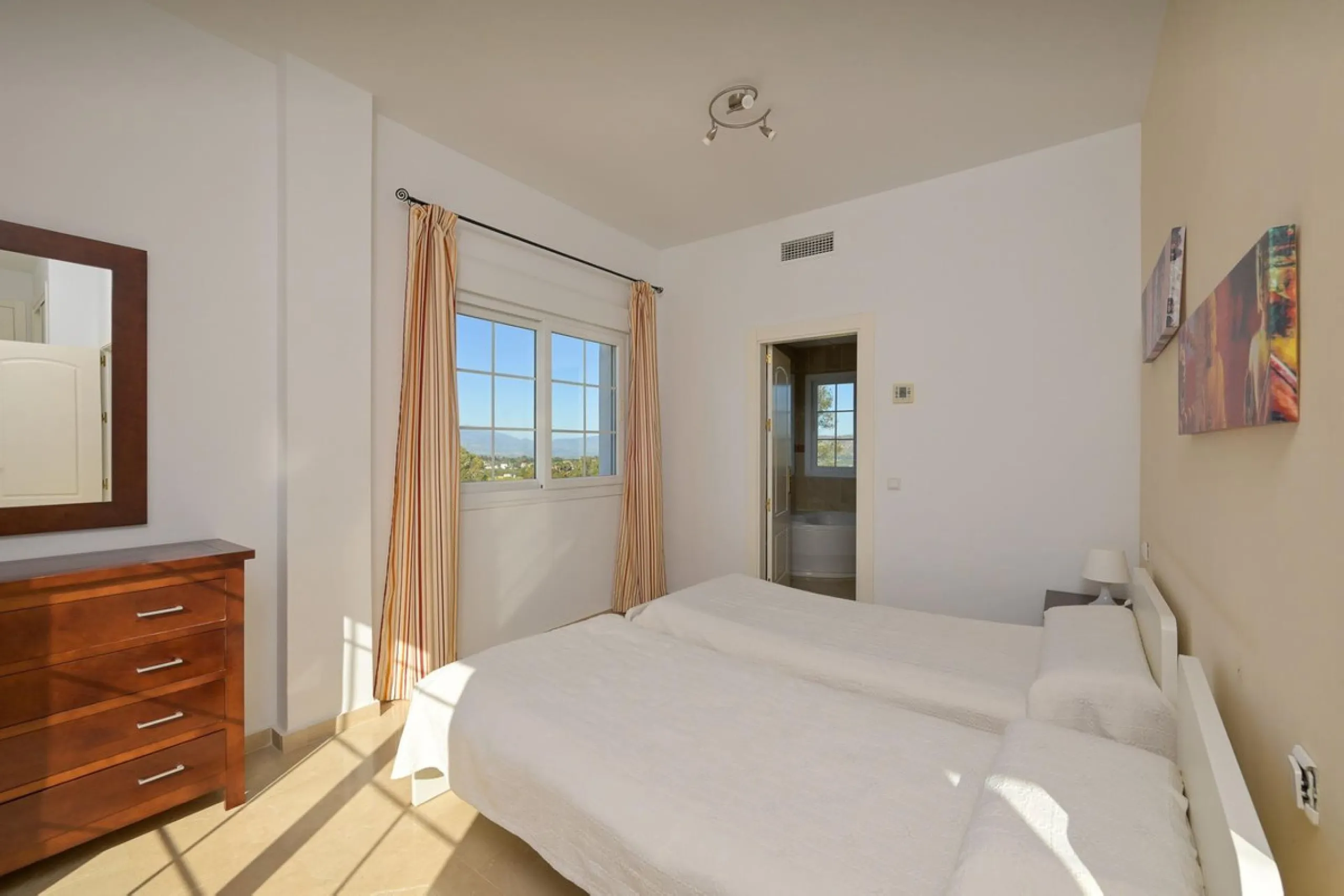Townhouse for sale in Lauro Golf one of the most prestigious golf courses in Malaga. The property is distributed over three floors. On the ground floor there is a fully equipped kitchen, a toilet, a large living room with a fireplace that leads to a priva