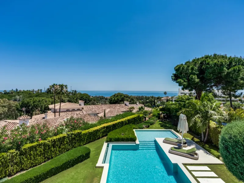This exceptional villa is nestled within an exclusive gated community in Marbella's prestigious Golden Mile. Set on a generous south-facing plot, the property is bathed in natural sunlight and enjoys breathtaking panoramic sea views from both floors, crea
