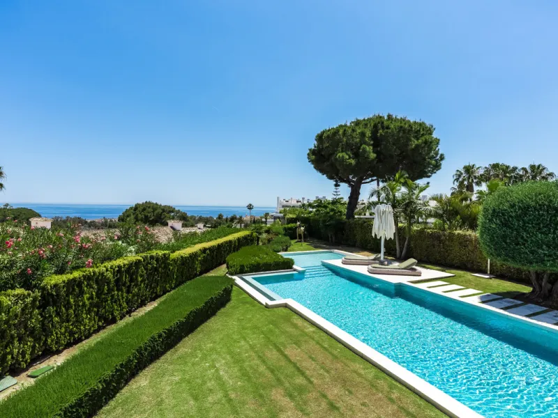 This exceptional villa is nestled within an exclusive gated community in Marbella's prestigious Golden Mile. Set on a generous south-facing plot, the property is bathed in natural sunlight and enjoys breathtaking panoramic sea views from both floors, crea