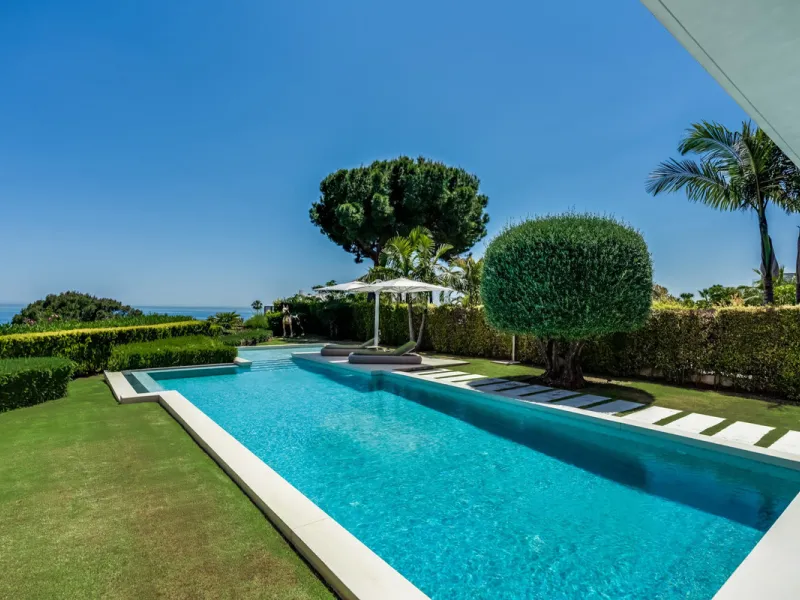 This exceptional villa is nestled within an exclusive gated community in Marbella's prestigious Golden Mile. Set on a generous south-facing plot, the property is bathed in natural sunlight and enjoys breathtaking panoramic sea views from both floors, crea