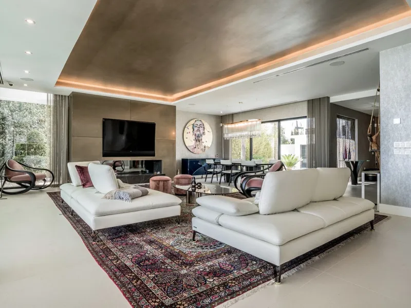 This exceptional villa is nestled within an exclusive gated community in Marbella's prestigious Golden Mile. Set on a generous south-facing plot, the property is bathed in natural sunlight and enjoys breathtaking panoramic sea views from both floors, crea