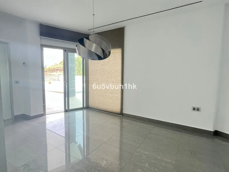This spacious modern villa is located in a prime area of Benalmádena, near Xanit Hospital, and enjoys clear views toward a protected area where construction is not permitted, ensuring privacy and the tranquility of having hardly any nearby neighbors.