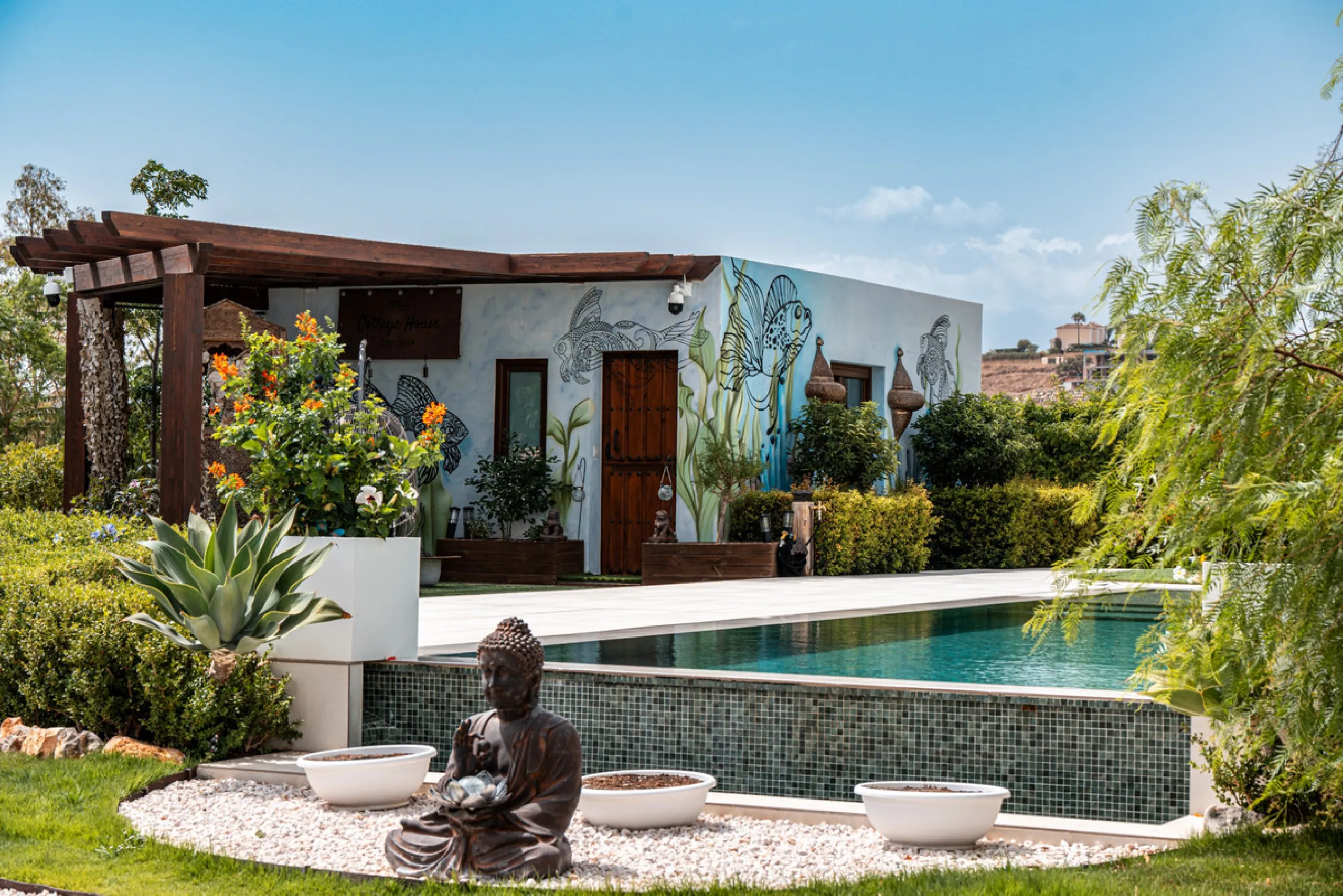 Villa TrueLove is a six-bedroom, five-bathroom luxury villa in the heart of Benahavís. It offers stunning mountain and garden views, combining modern technology with natural design. The home features a seamless connection between indoor and outdoor living