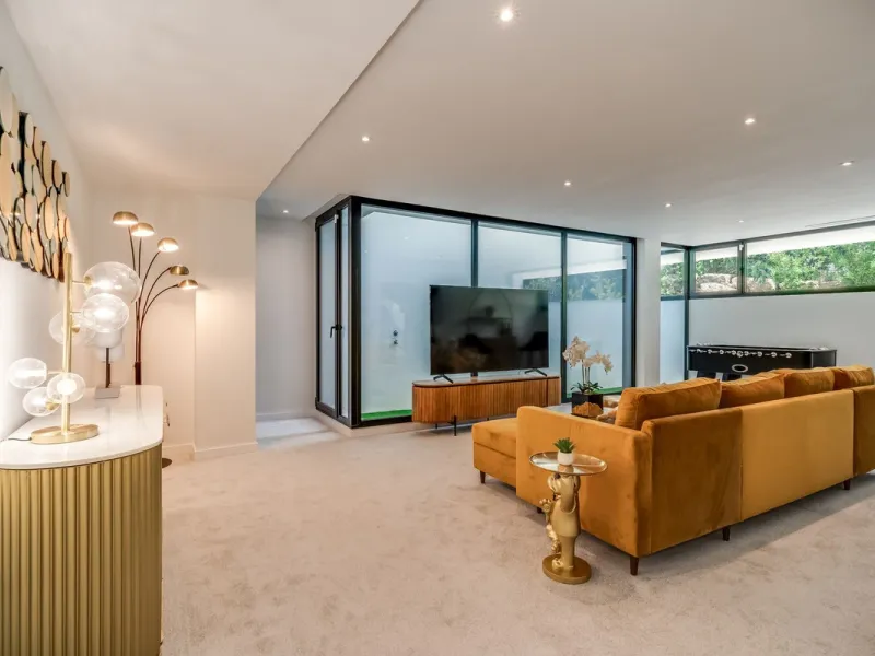 Nestled along the lush greens of Marbella's finest golf course of El Campanario, this luxurious 5-bedroom, 4.5-bath villa offers a seamless blend of elegance and state-of-the-art comfort over 460 square meters of living space. The villa's open layout invi