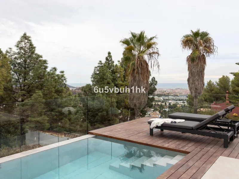 Exquisite modern villa, a newly built family home that perfectly blends contemporary design with comfort and convenience. Nestled in the desirable neighborhood of El Atabal, Malaga, this three-story residence offers breathtaking sea and mountain views fro
