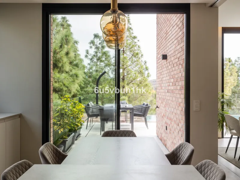Exquisite modern villa, a newly built family home that perfectly blends contemporary design with comfort and convenience. Nestled in the desirable neighborhood of El Atabal, Malaga, this three-story residence offers breathtaking sea and mountain views fro