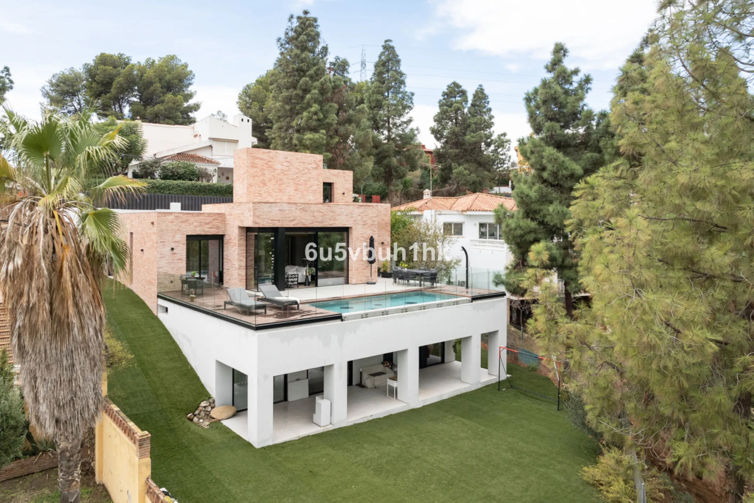 Exquisite modern villa, a newly built family home that perfectly blends contemporary design with comfort and convenience. Nestled in the desirable neighborhood of El Atabal, Malaga, this three-story residence offers breathtaking sea and mountain views fro