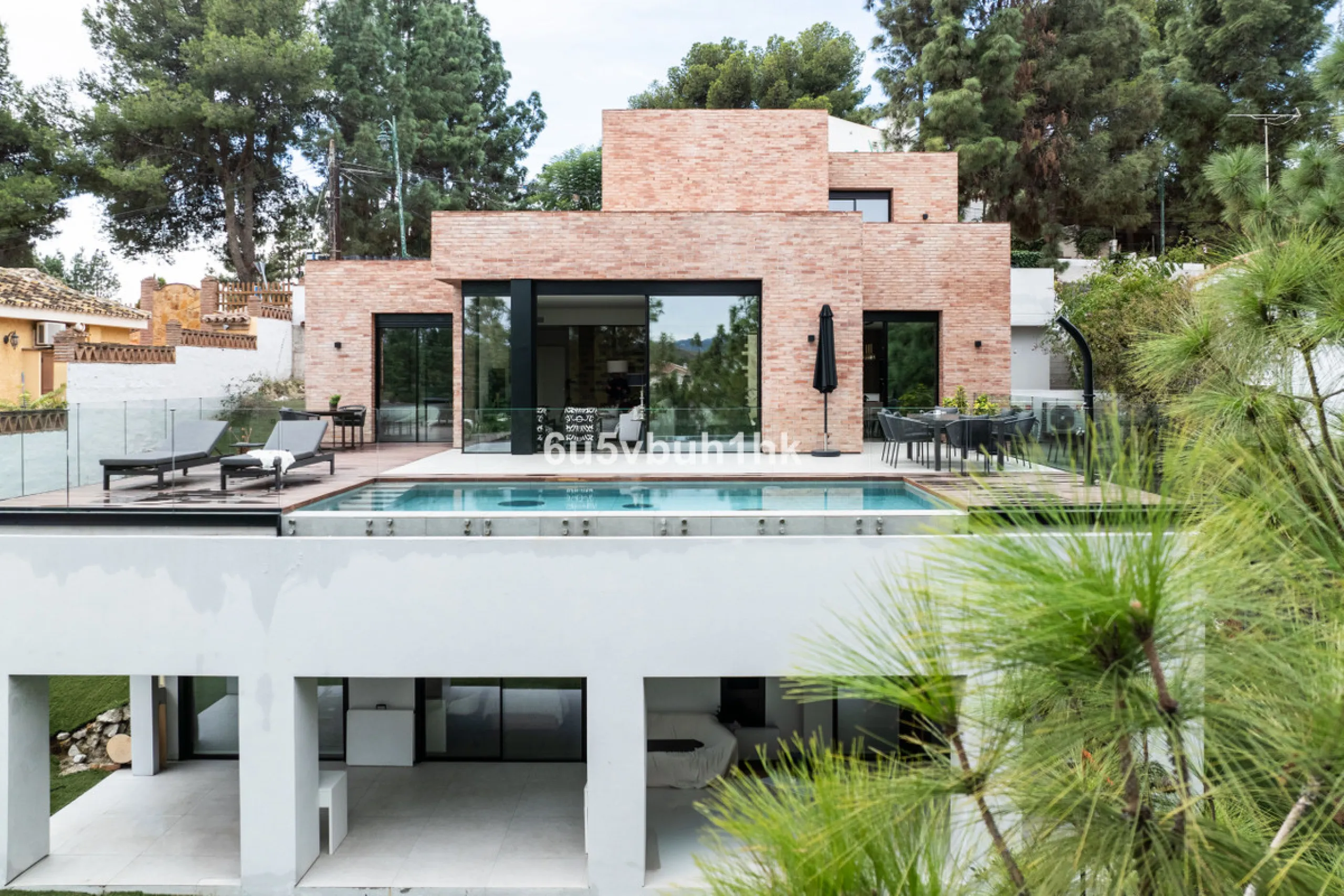 Exquisite modern villa, a newly built family home that perfectly blends contemporary design with comfort and convenience. Nestled in the desirable neighborhood of El Atabal, Malaga, this three-story residence offers breathtaking sea and mountain views fro