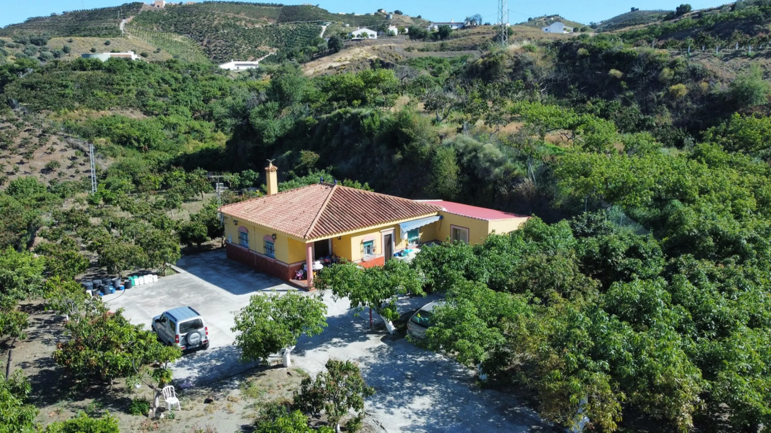 This charming finca is situated in a serene and peaceful location, offering picturesque views of the surrounding landscape. The expansive property boasts 280 magnificent mango trees, 90 stately avocado trees, and several blooming citrus trees, creating a 