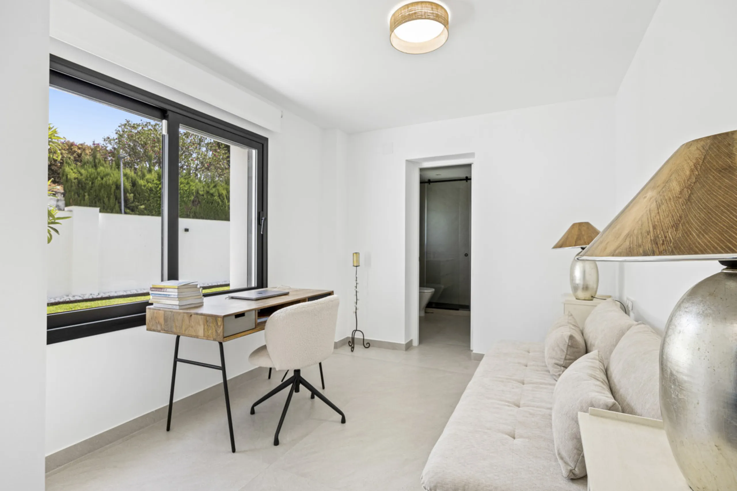 This west-facing villa boasts a modern design and is ideally situated next to the Guadalmina Golf Course. The property, spans two levels, offers privacy, convenience, and ample space for a large family.