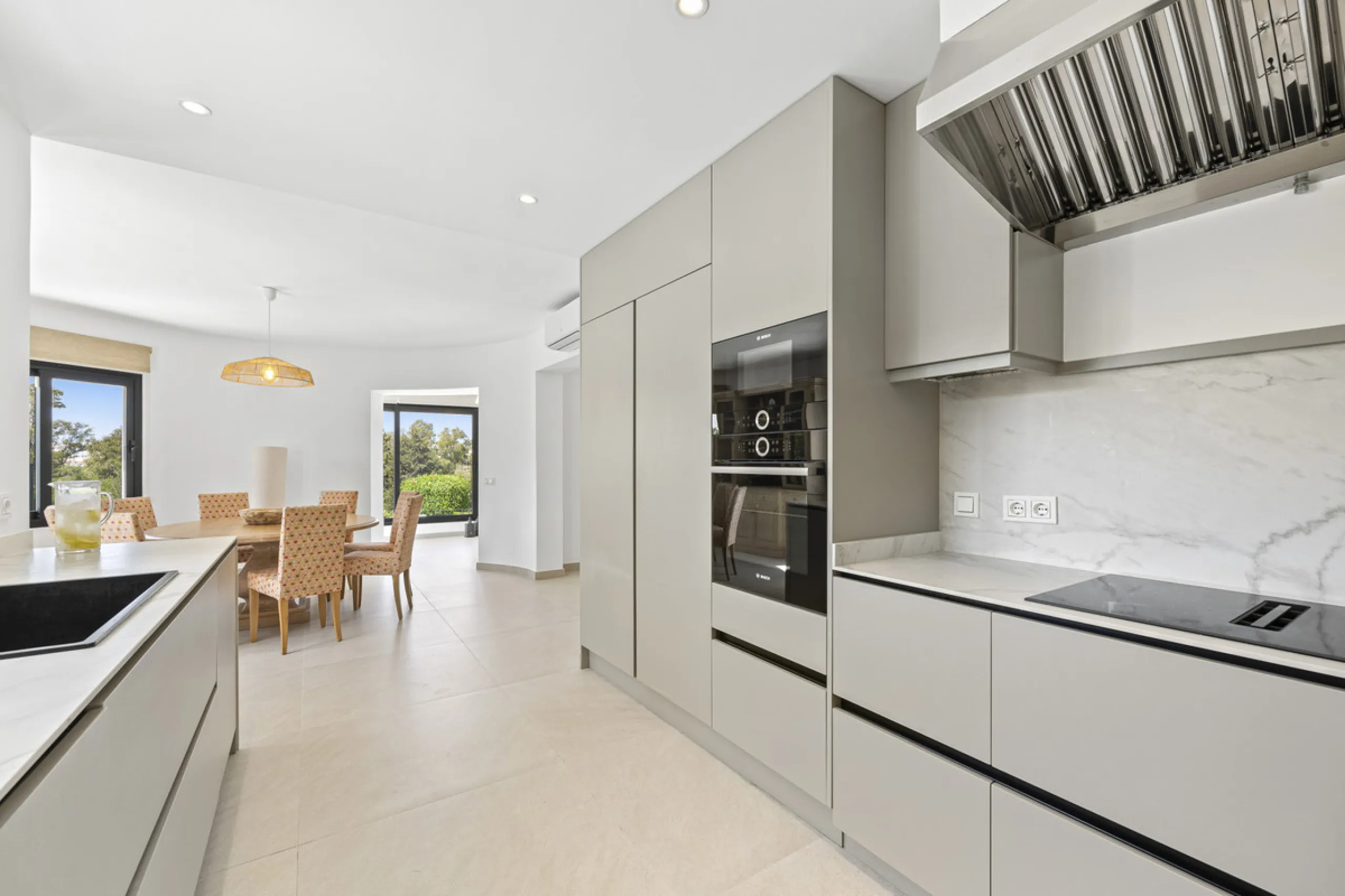 This west-facing villa boasts a modern design and is ideally situated next to the Guadalmina Golf Course. The property, spans two levels, offers privacy, convenience, and ample space for a large family.