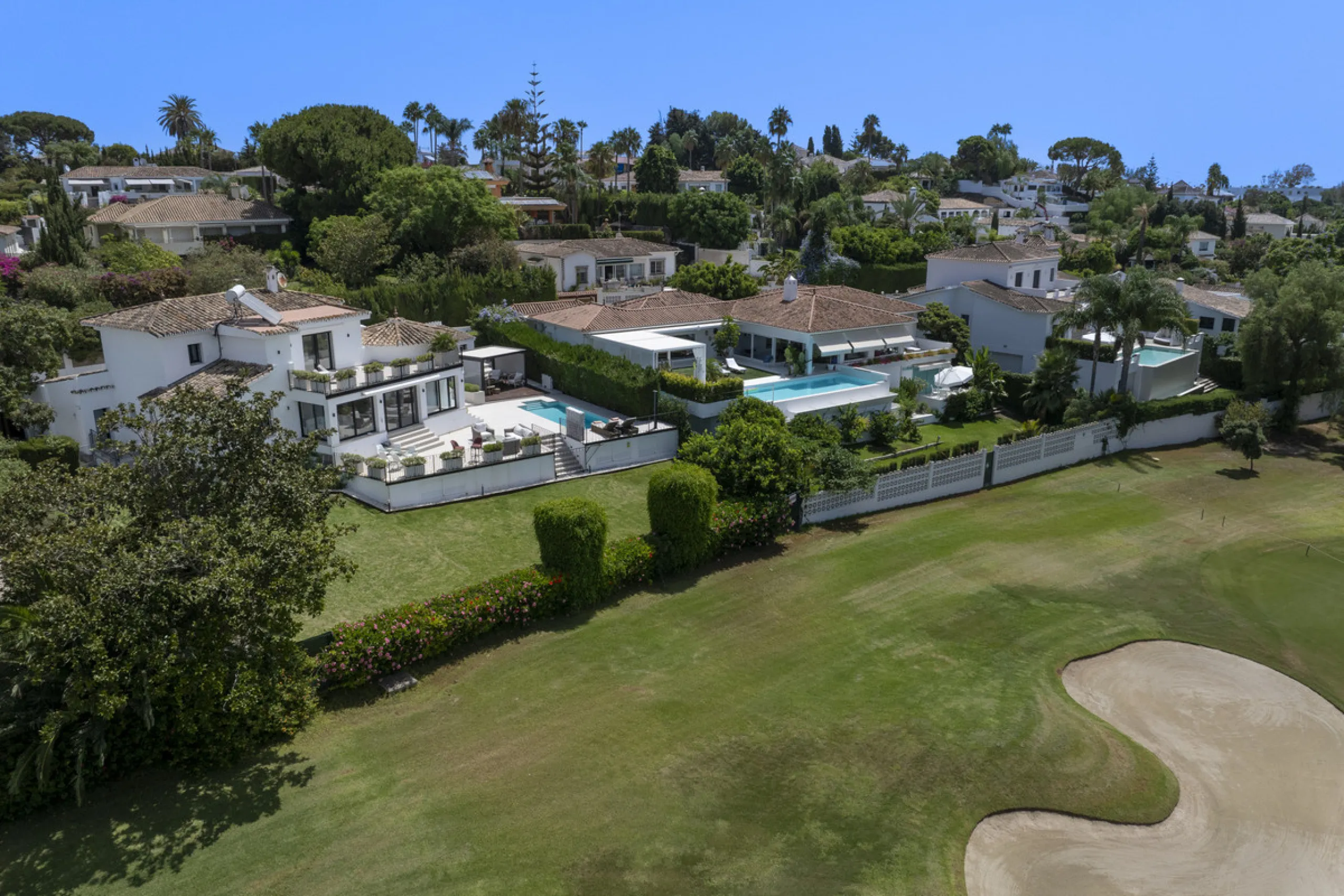 This west-facing villa boasts a modern design and is ideally situated next to the Guadalmina Golf Course. The property, spans two levels, offers privacy, convenience, and ample space for a large family.