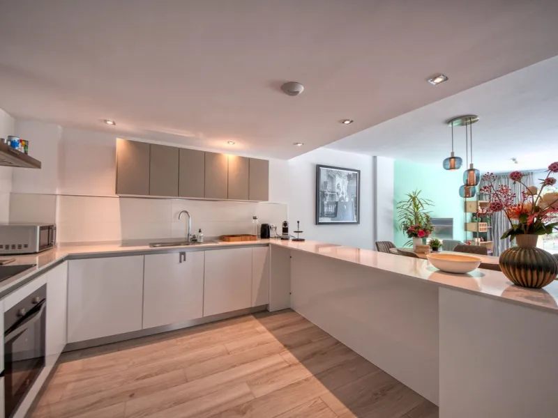 Spacious penthouse in Benahavis with the following layout. The main floor features an open-plan living area leading to a terrace with views over the pool and village. The modern kitchen is fully equipped with top-of-the-line appliances and additional stor