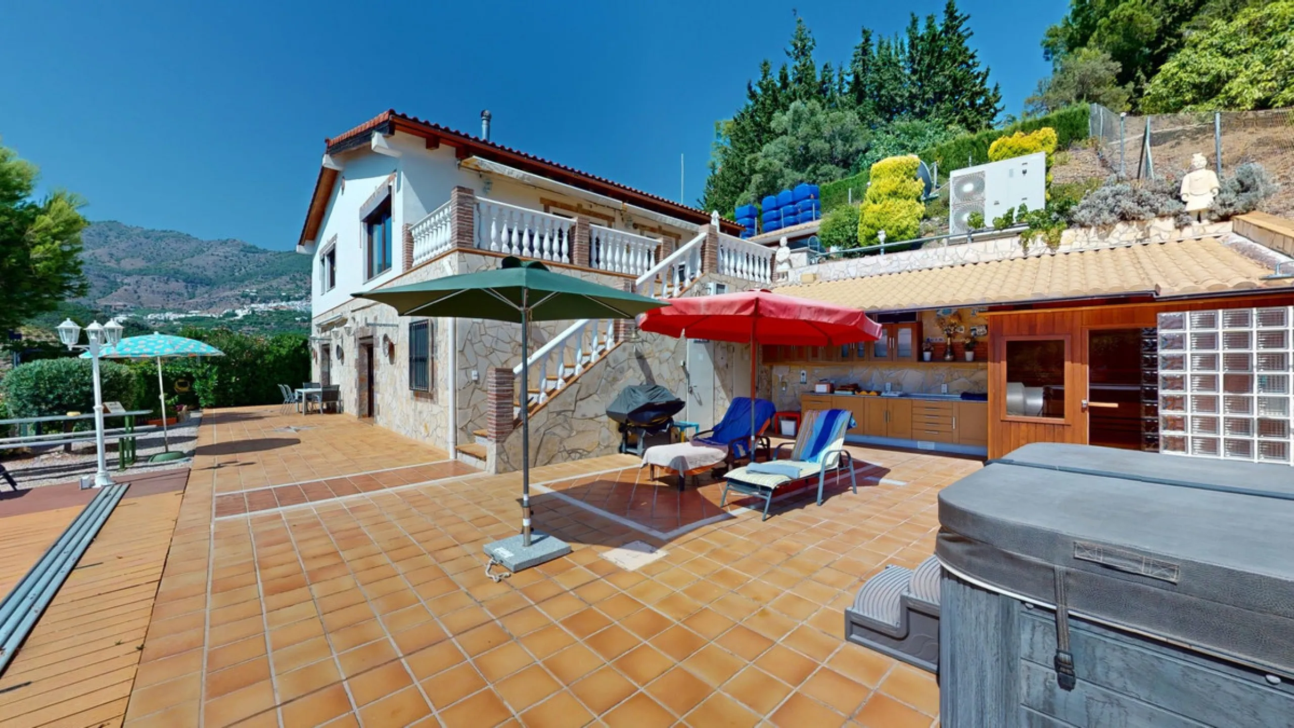 Stunning Villa Below Frigiliana for Sale. This impressive villa, nestled below Frigiliana, offers two separate living units across two floors, each with its own driveway and privacy. The upper unit spans 150 m2 and features a spacious open-plan living and