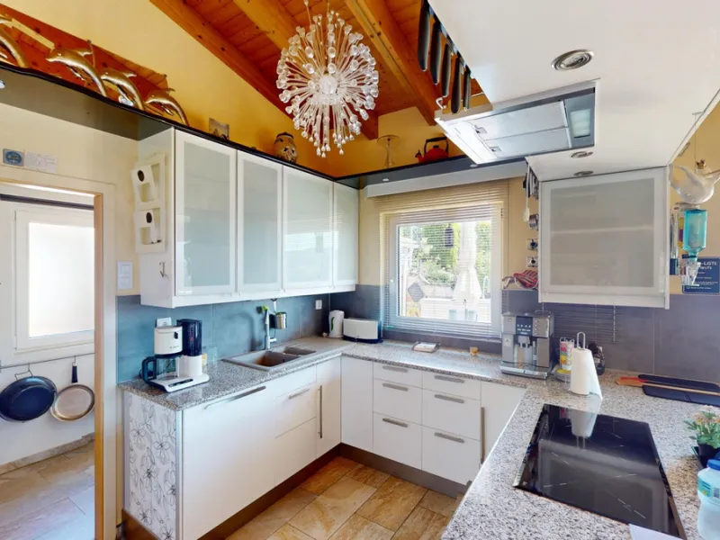 Stunning Villa Below Frigiliana for Sale. This impressive villa, nestled below Frigiliana, offers two separate living units across two floors, each with its own driveway and privacy. The upper unit spans 150 m2 and features a spacious open-plan living and