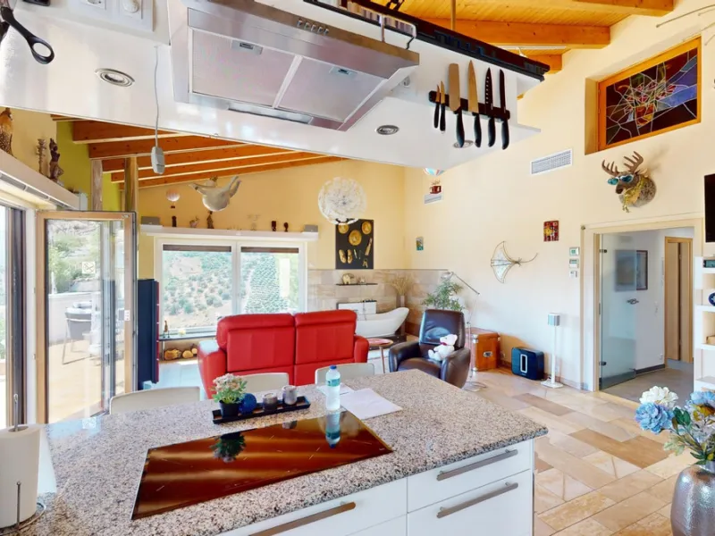 Stunning Villa Below Frigiliana for Sale. This impressive villa, nestled below Frigiliana, offers two separate living units across two floors, each with its own driveway and privacy. The upper unit spans 150 m2 and features a spacious open-plan living and