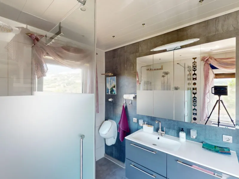 Stunning Villa Below Frigiliana for Sale. This impressive villa, nestled below Frigiliana, offers two separate living units across two floors, each with its own driveway and privacy. The upper unit spans 150 m2 and features a spacious open-plan living and
