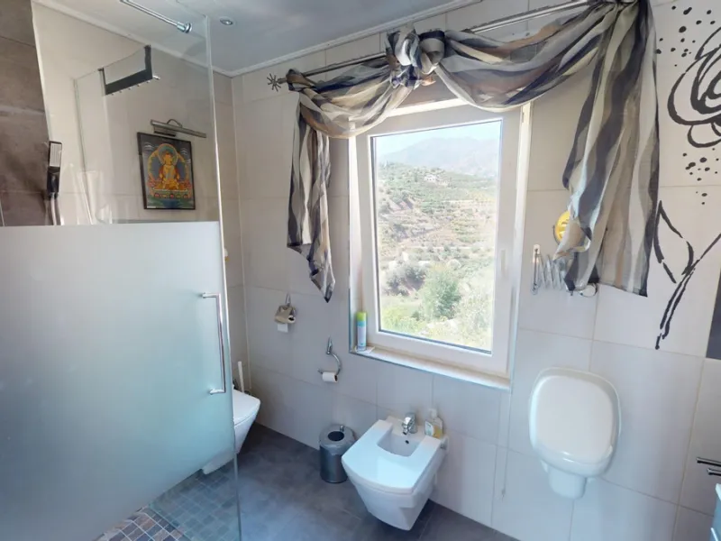 Stunning Villa Below Frigiliana for Sale. This impressive villa, nestled below Frigiliana, offers two separate living units across two floors, each with its own driveway and privacy. The upper unit spans 150 m2 and features a spacious open-plan living and