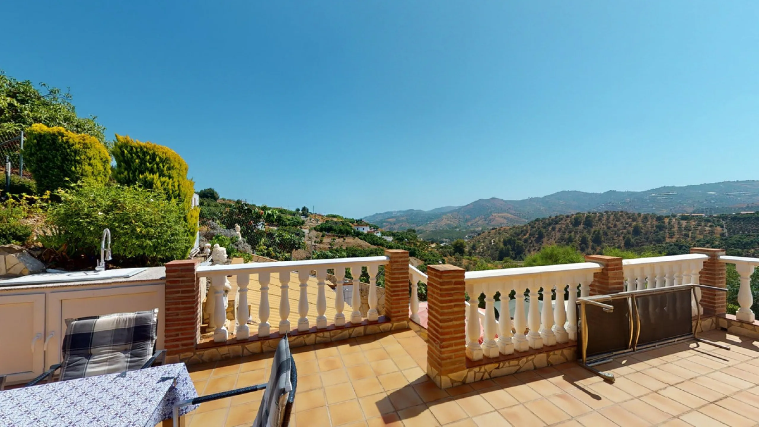 Stunning Villa Below Frigiliana for Sale. This impressive villa, nestled below Frigiliana, offers two separate living units across two floors, each with its own driveway and privacy. The upper unit spans 150 m2 and features a spacious open-plan living and