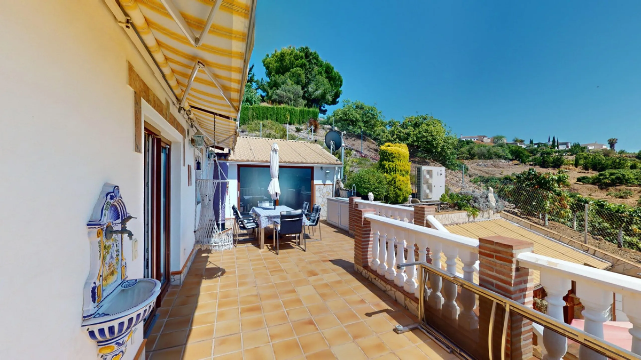 Stunning Villa Below Frigiliana for Sale. This impressive villa, nestled below Frigiliana, offers two separate living units across two floors, each with its own driveway and privacy. The upper unit spans 150 m2 and features a spacious open-plan living and