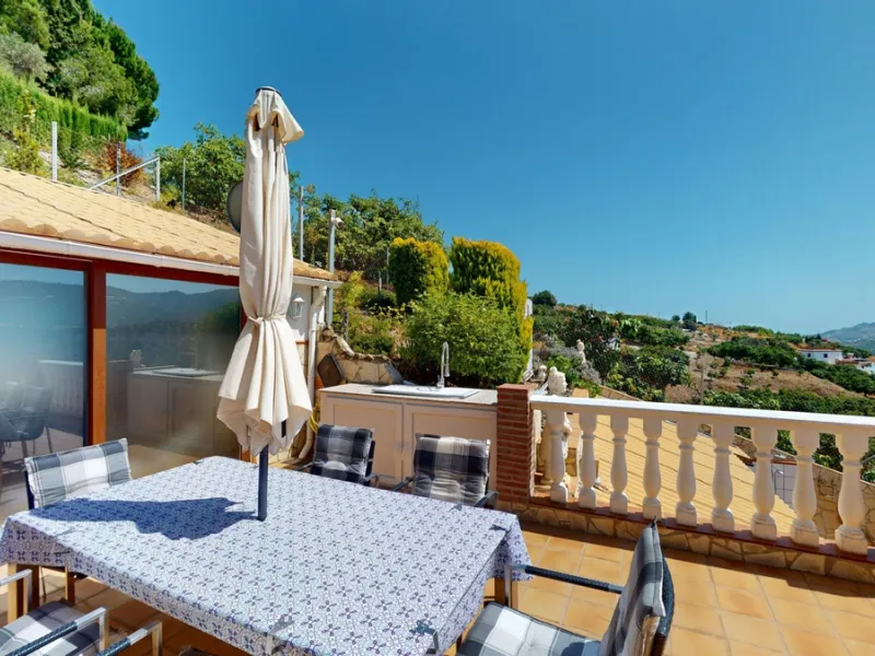 Stunning Villa Below Frigiliana for Sale. This impressive villa, nestled below Frigiliana, offers two separate living units across two floors, each with its own driveway and privacy. The upper unit spans 150 m2 and features a spacious open-plan living and