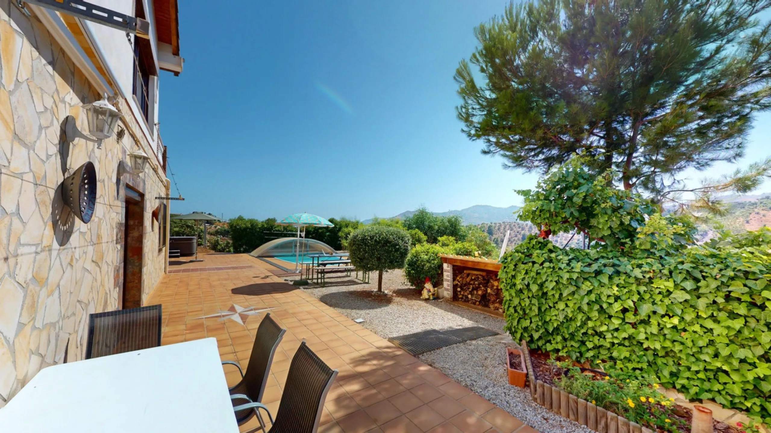 Stunning Villa Below Frigiliana for Sale. This impressive villa, nestled below Frigiliana, offers two separate living units across two floors, each with its own driveway and privacy. The upper unit spans 150 m2 and features a spacious open-plan living and