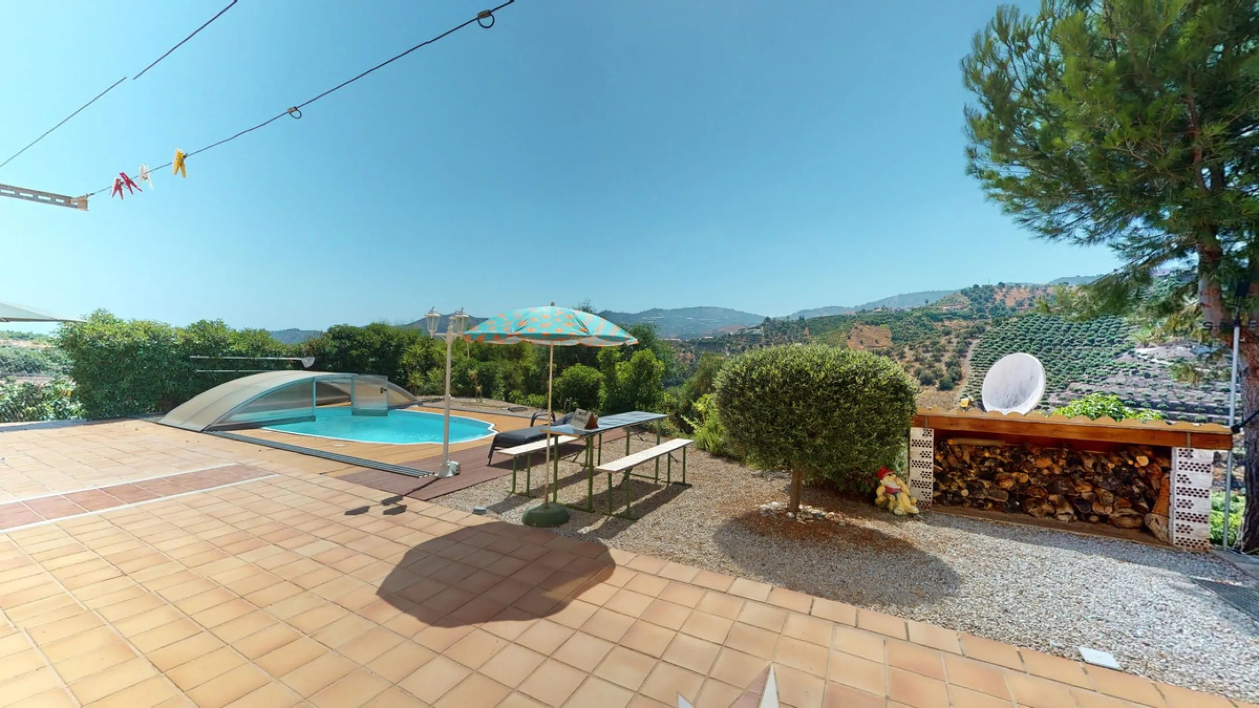 Stunning Villa Below Frigiliana for Sale. This impressive villa, nestled below Frigiliana, offers two separate living units across two floors, each with its own driveway and privacy. The upper unit spans 150 m2 and features a spacious open-plan living and