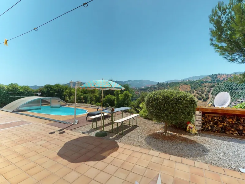 Stunning Villa Below Frigiliana for Sale. This impressive villa, nestled below Frigiliana, offers two separate living units across two floors, each with its own driveway and privacy. The upper unit spans 150 m2 and features a spacious open-plan living and