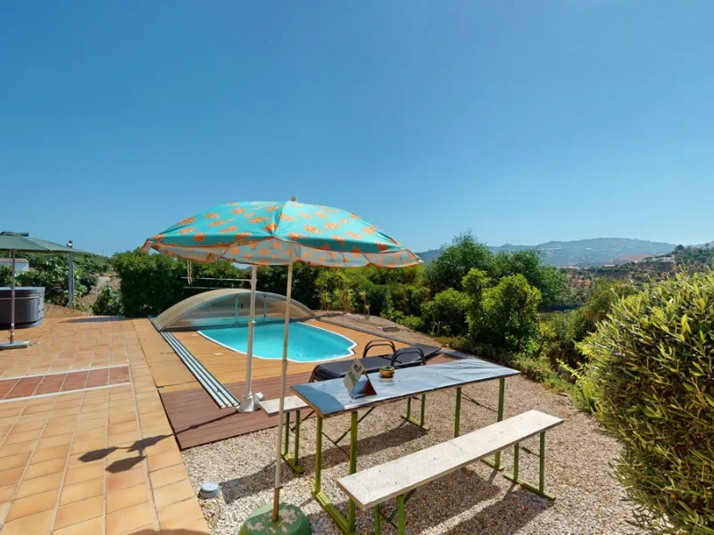 Stunning Villa Below Frigiliana for Sale. This impressive villa, nestled below Frigiliana, offers two separate living units across two floors, each with its own driveway and privacy. The upper unit spans 150 m2 and features a spacious open-plan living and