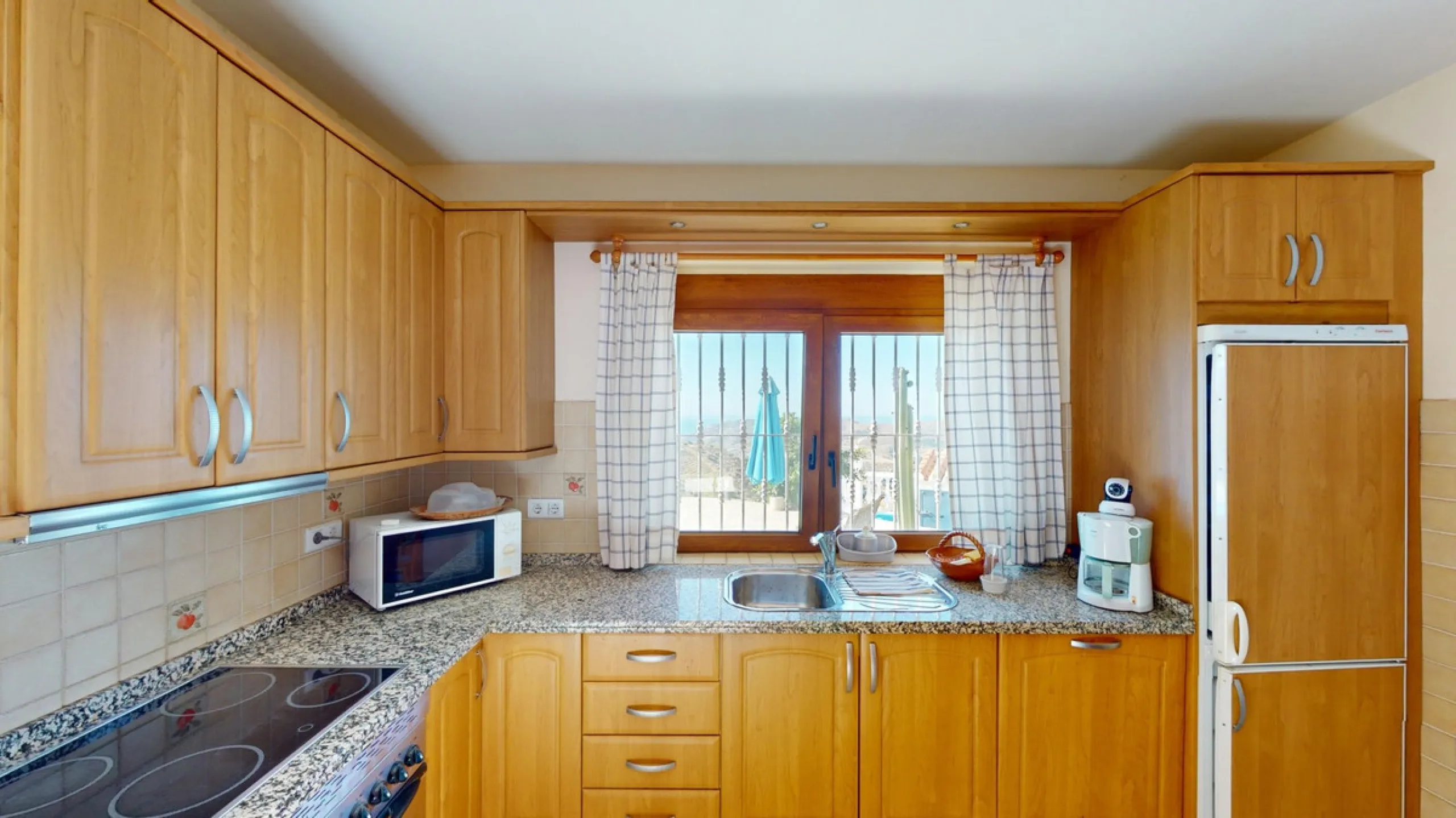 This exceptional, spacious U-shaped villa is located in the picturesque area of Iznate and offers two separate living units, each fully equipped. The villa spans two floors and features a total of seven bedrooms and six bathrooms. Each unit includes a fun