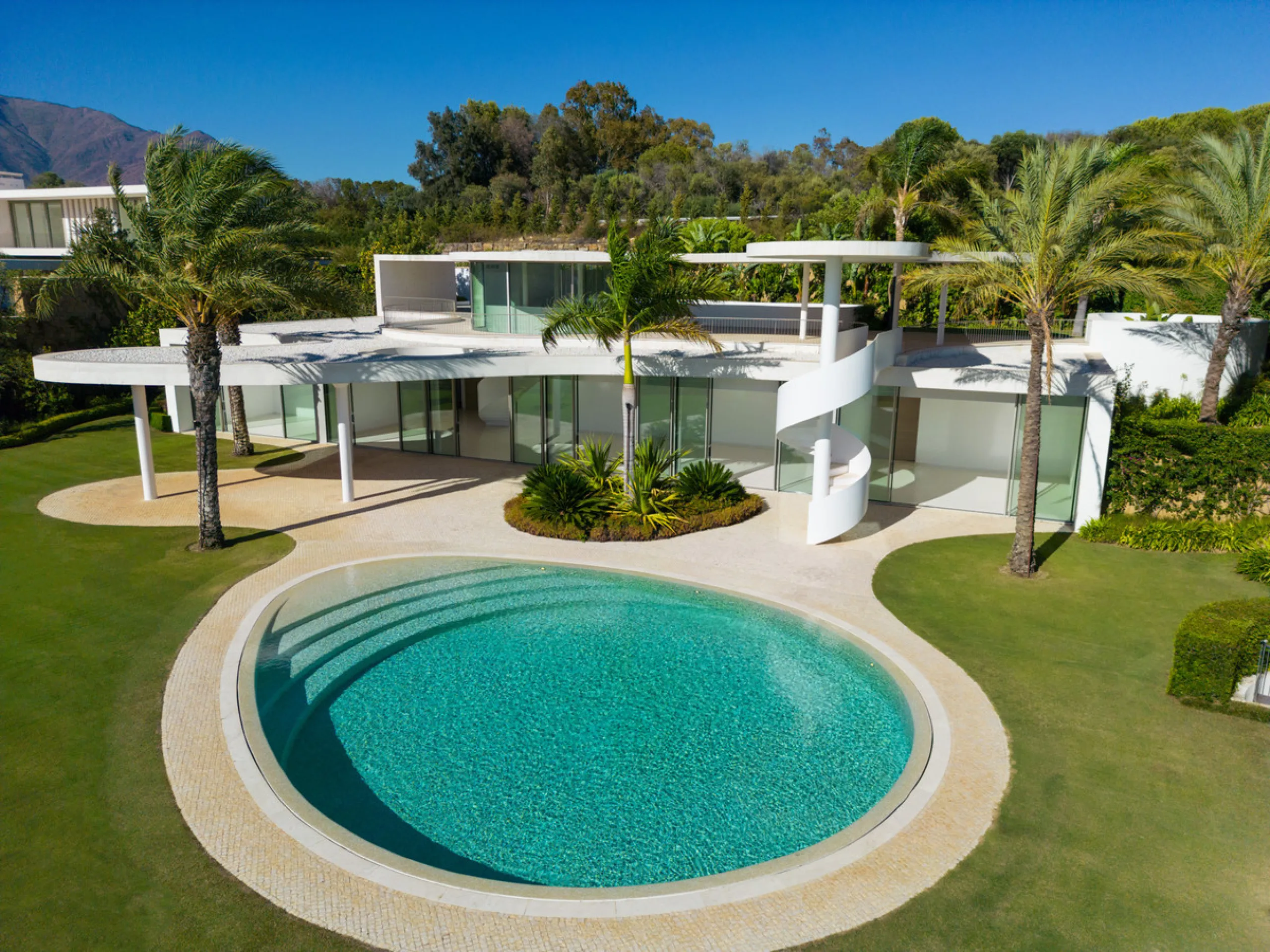 This prestigious villa stands as a testament to architectural ingenuity, capturing the essence of uniqueness and sophistication. Designed by the visionary minds of Vicens & Ramos architects, its futuristic yet nostalgic structure commands attention with i