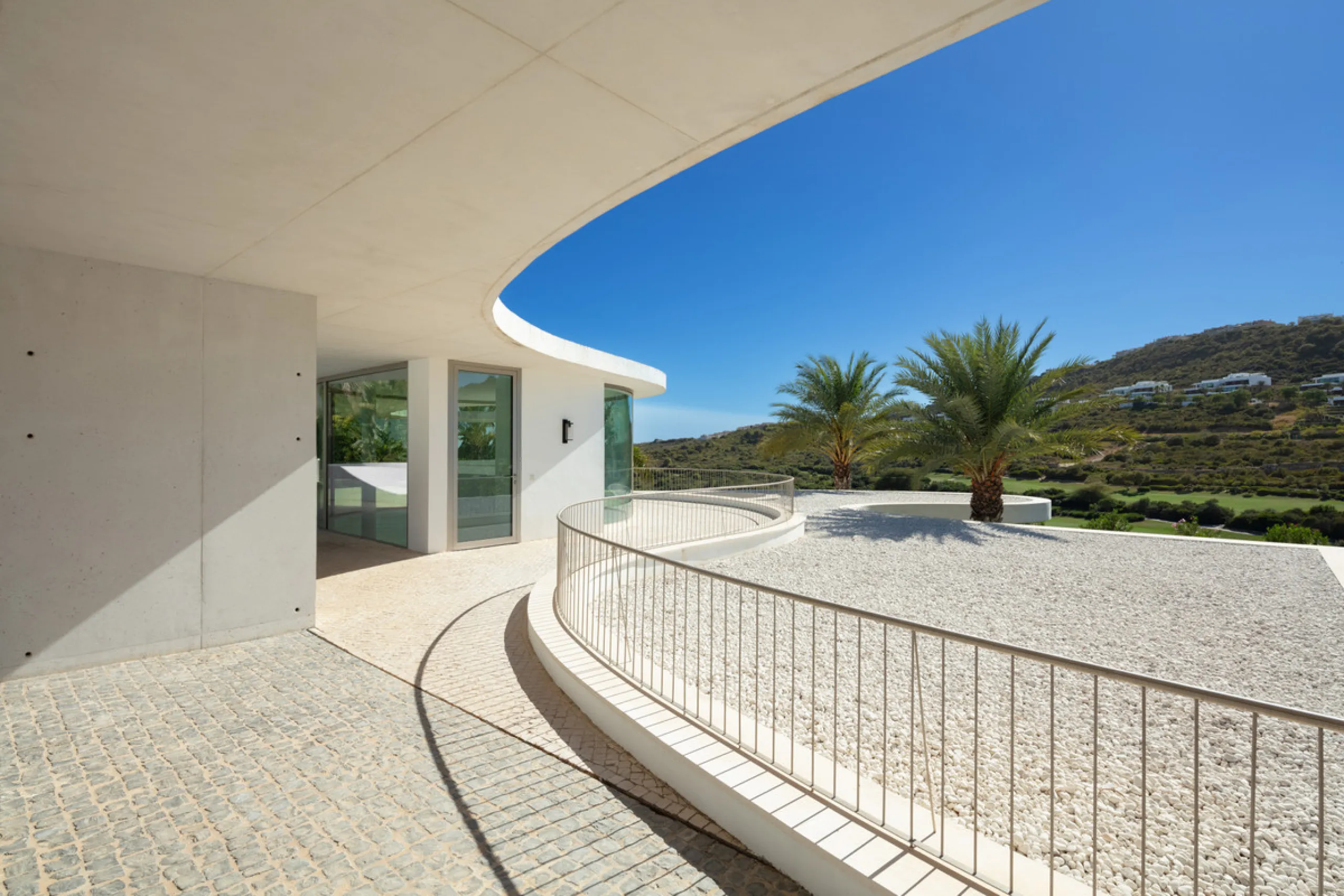 This prestigious villa stands as a testament to architectural ingenuity, capturing the essence of uniqueness and sophistication. Designed by the visionary minds of Vicens & Ramos architects, its futuristic yet nostalgic structure commands attention with i