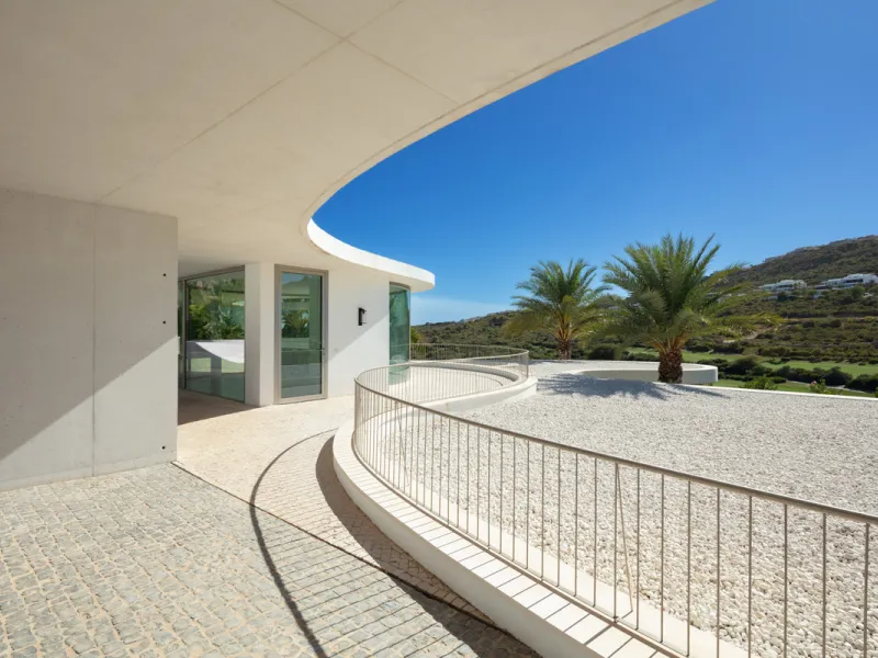 This prestigious villa stands as a testament to architectural ingenuity, capturing the essence of uniqueness and sophistication. Designed by the visionary minds of Vicens & Ramos architects, its futuristic yet nostalgic structure commands attention with i