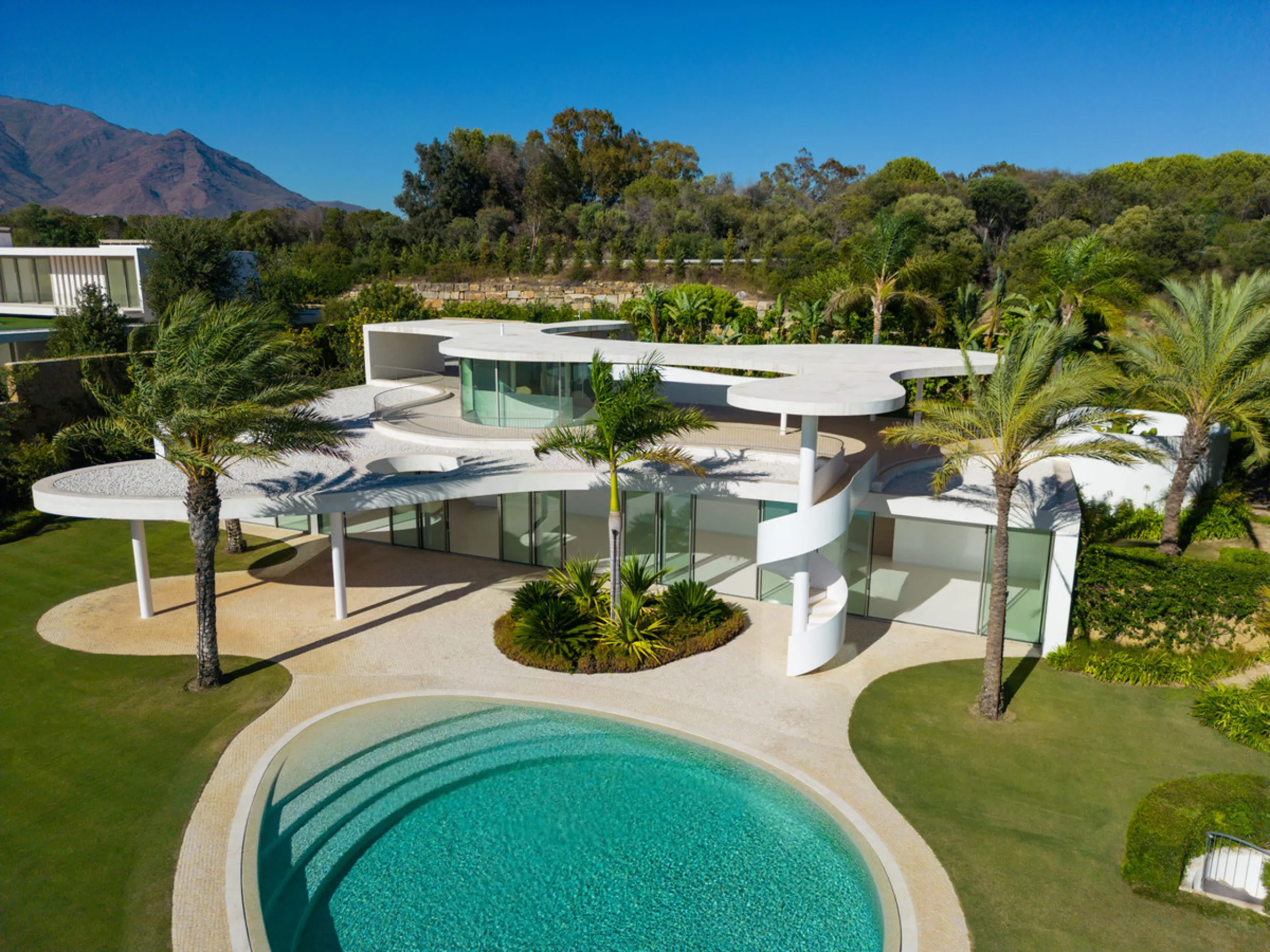 This prestigious villa stands as a testament to architectural ingenuity, capturing the essence of uniqueness and sophistication. Designed by the visionary minds of Vicens & Ramos architects, its futuristic yet nostalgic structure commands attention with i