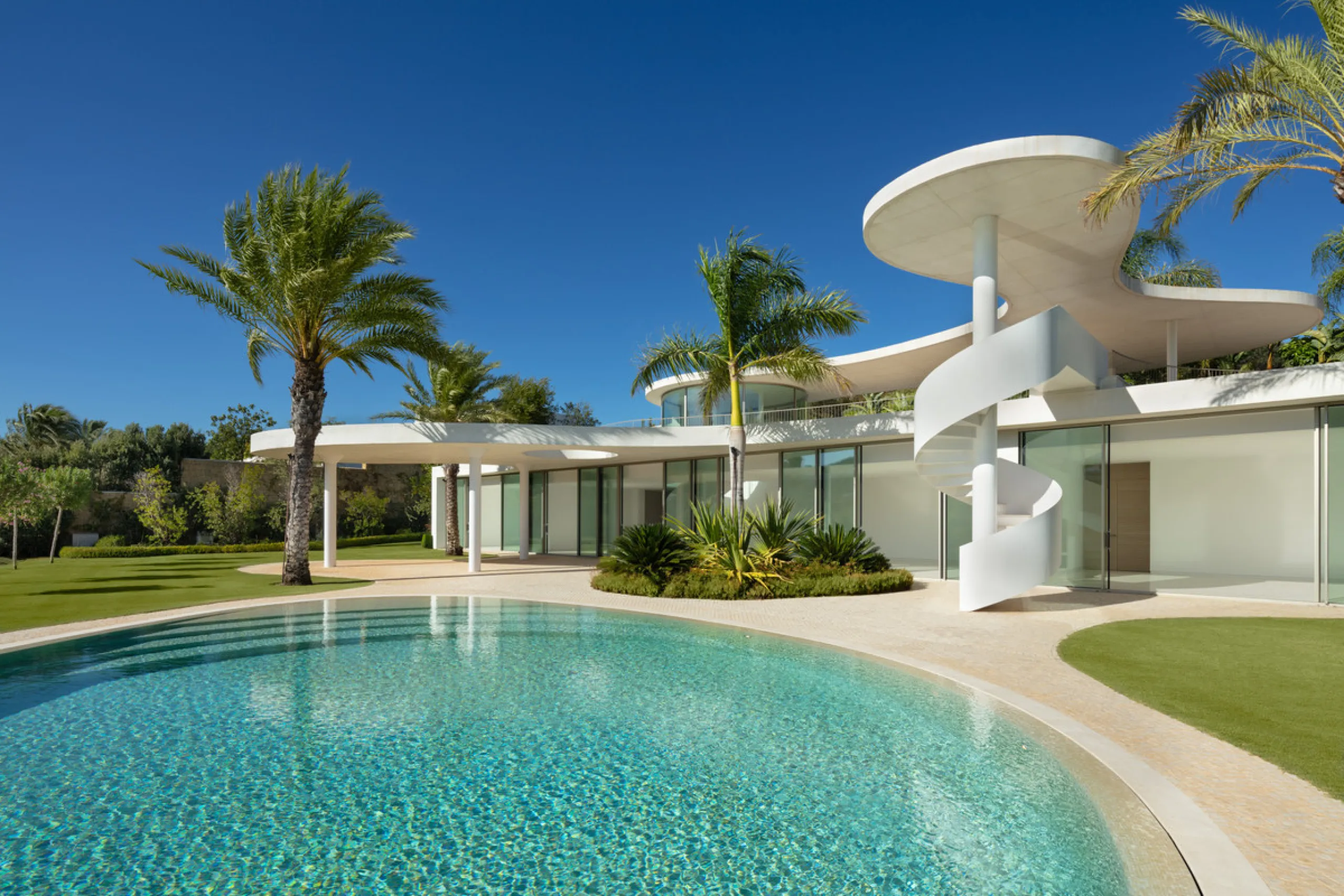 This prestigious villa stands as a testament to architectural ingenuity, capturing the essence of uniqueness and sophistication. Designed by the visionary minds of Vicens & Ramos architects, its futuristic yet nostalgic structure commands attention with i