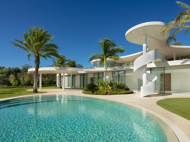 This prestigious villa stands as a testament to architectural ingenuity, capturing the essence of uniqueness and sophistication. Designed by the visionary minds of Vicens & Ramos architects, its futuristic yet nostalgic structure commands attention with i