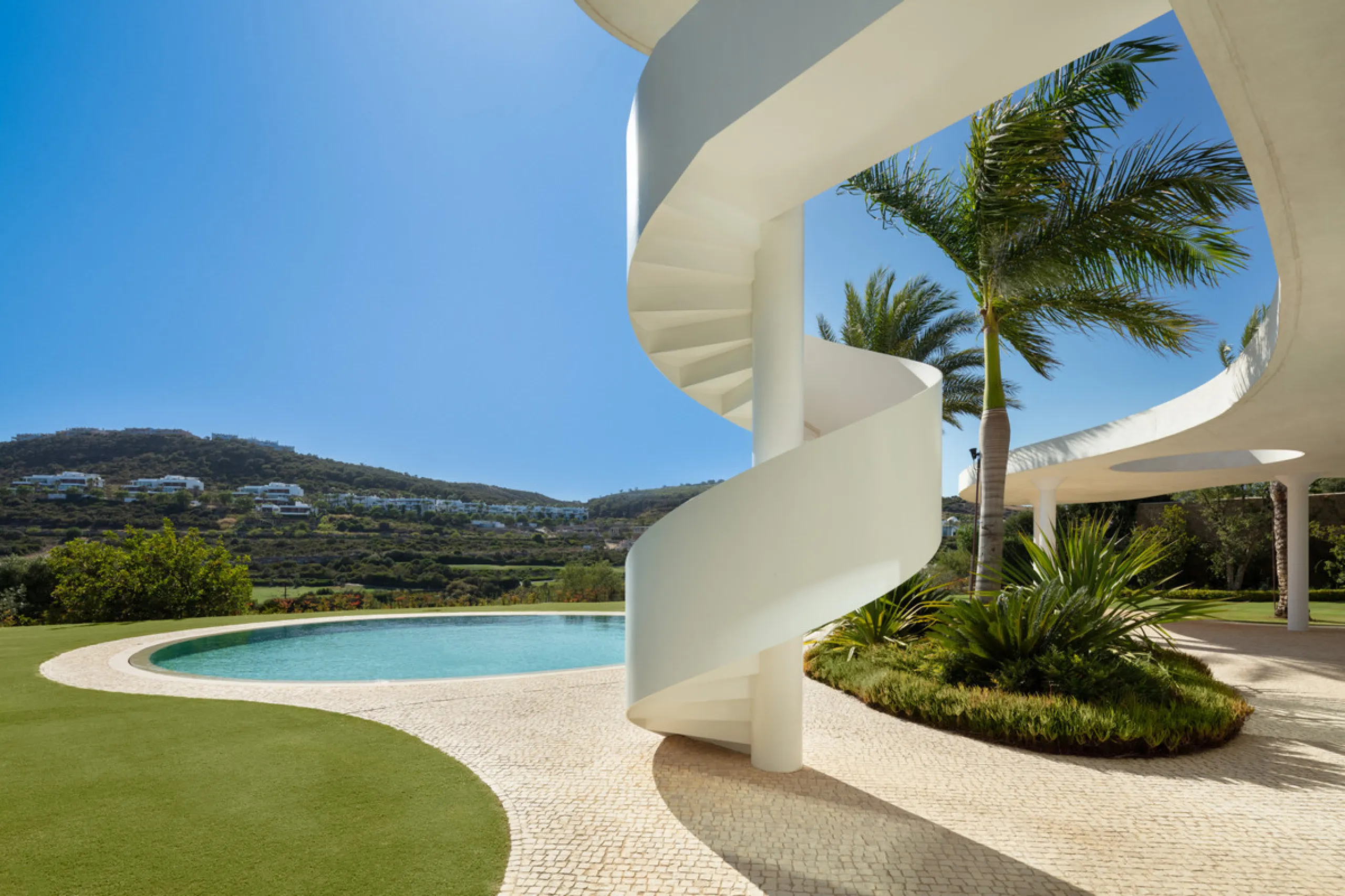 This prestigious villa stands as a testament to architectural ingenuity, capturing the essence of uniqueness and sophistication. Designed by the visionary minds of Vicens & Ramos architects, its futuristic yet nostalgic structure commands attention with i