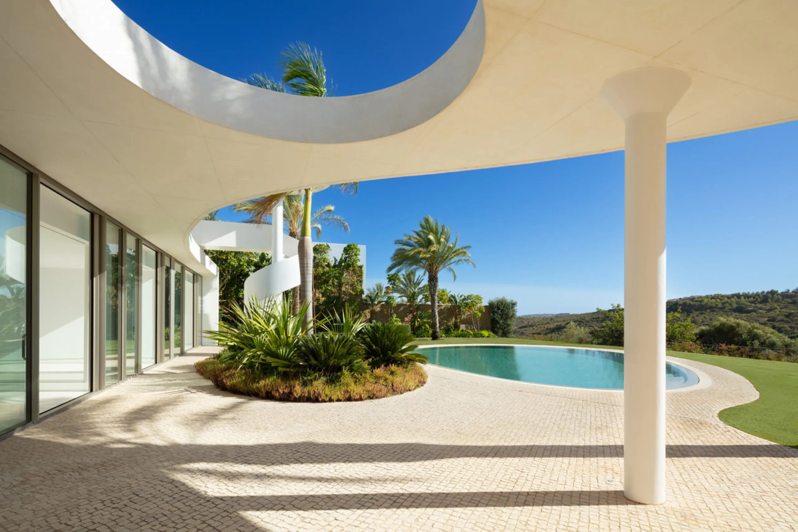 This prestigious villa stands as a testament to architectural ingenuity, capturing the essence of uniqueness and sophistication. Designed by the visionary minds of Vicens & Ramos architects, its futuristic yet nostalgic structure commands attention with i