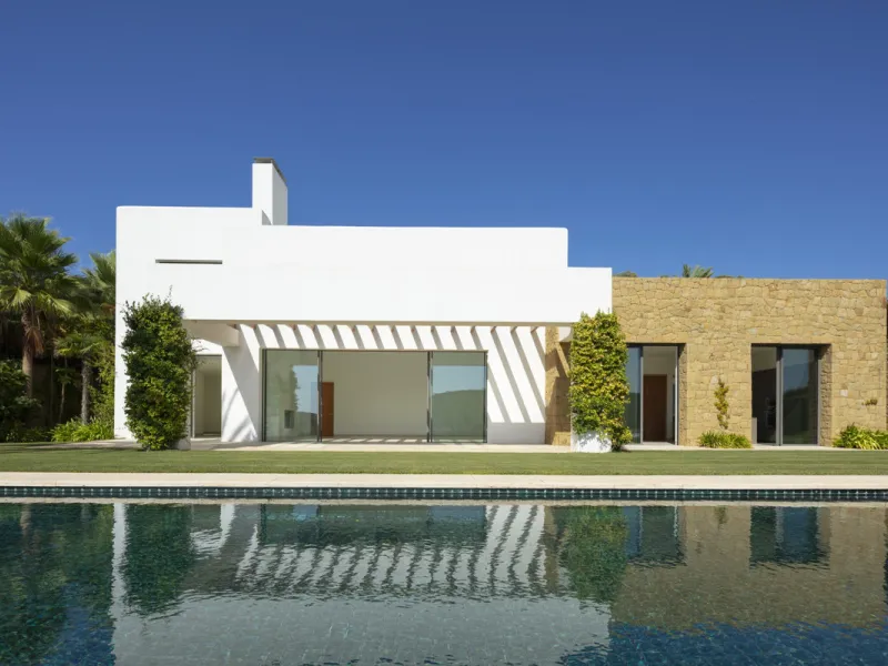 Nestled within the enclave of Green 10 in the Finca Cortesin resort, this villa exudes the charm of Ibiza-style residences. The white structure, adorned with traditional Mediterranean stones, creates a captivating atmosphere for ultimate enjoyment. Set on