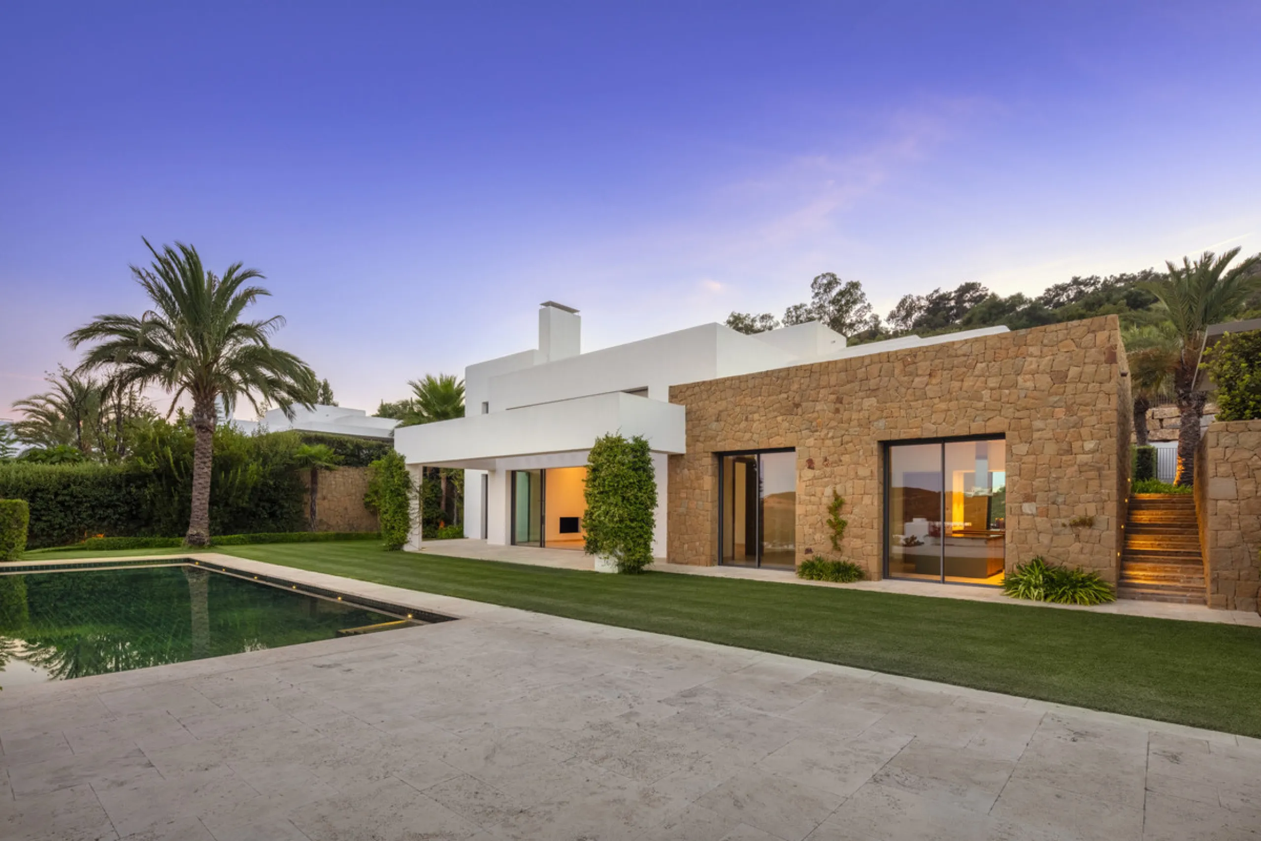 Nestled within the enclave of Green 10 in the Finca Cortesin resort, this villa exudes the charm of Ibiza-style residences. The white structure, adorned with traditional Mediterranean stones, creates a captivating atmosphere for ultimate enjoyment. Set on