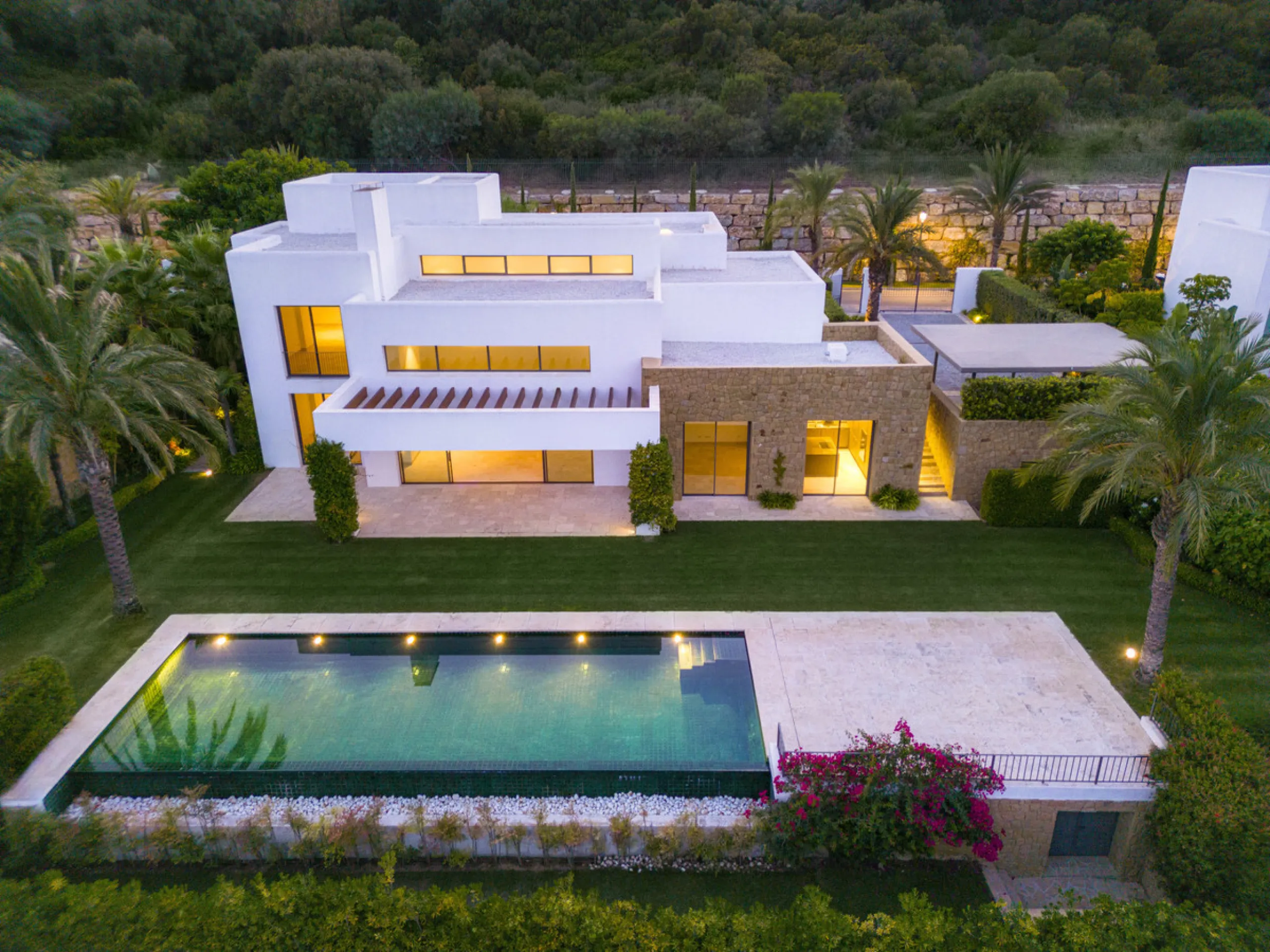 Nestled within the enclave of Green 10 in the Finca Cortesin resort, this villa exudes the charm of Ibiza-style residences. The white structure, adorned with traditional Mediterranean stones, creates a captivating atmosphere for ultimate enjoyment. Set on