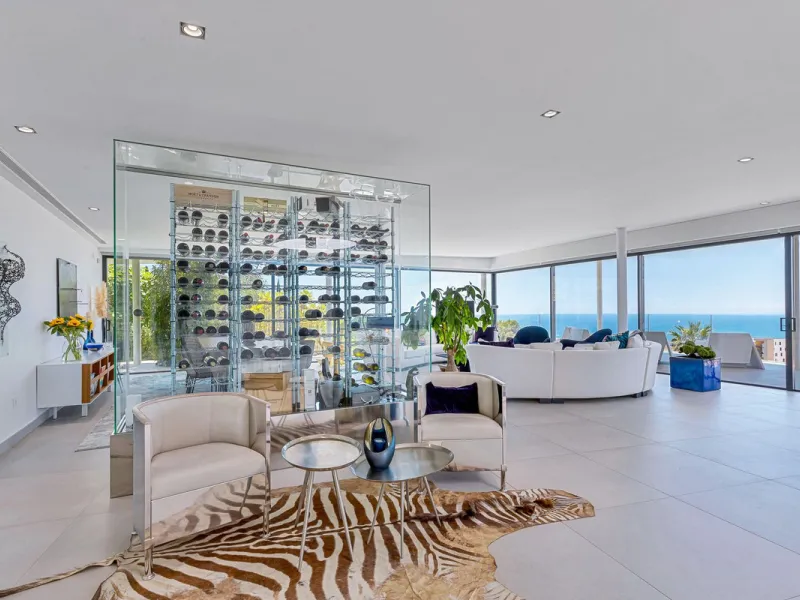Contemporary designer villa with breathtaking views towards the sea. The villa comprises of two floors with main entrance on the upper level. From the moment you step through the front door, you are struck by the fantastic view thanks to the floor-to-ceil