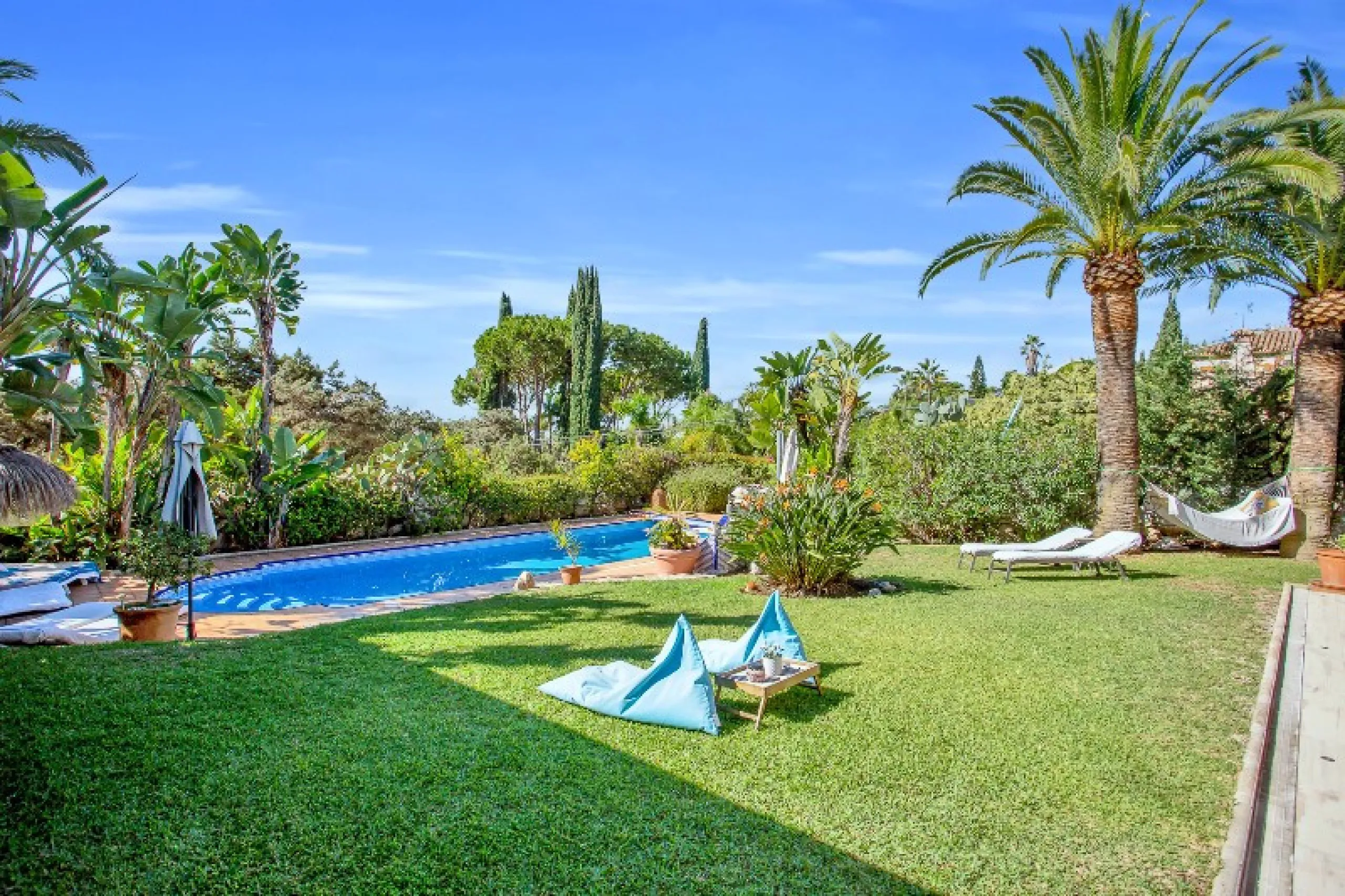 Luxury family villa in MARBESA, one of the most exclusive areas of Marbella. A desirable large open-plan villa on a flat south-west facing plot with mature landscaped gardens and large heated pool, and with wonderful panoramic sea views, only a few minute