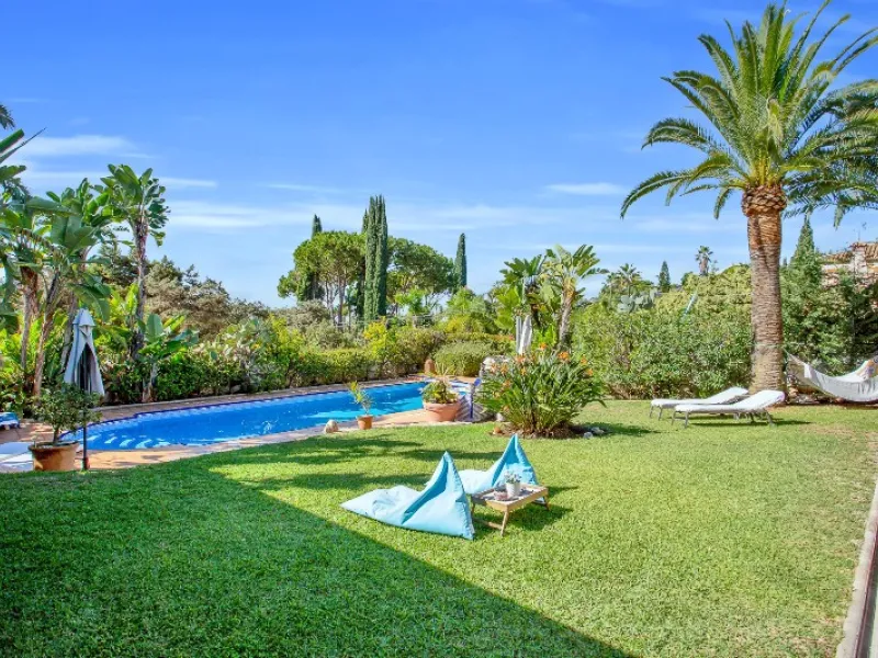 Luxury family villa in MARBESA, one of the most exclusive areas of Marbella. A desirable large open-plan villa on a flat south-west facing plot with mature landscaped gardens and large heated pool, and with wonderful panoramic sea views, only a few minute