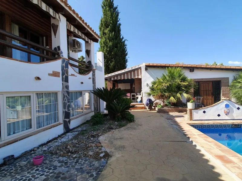 Charming Country Property for sale featuring two houses and two apartments, along with two swimming pools. This property holds a licence for rural tourism and is conveniently located very close to the town, surrounded by a fence ensuring privacy and secur