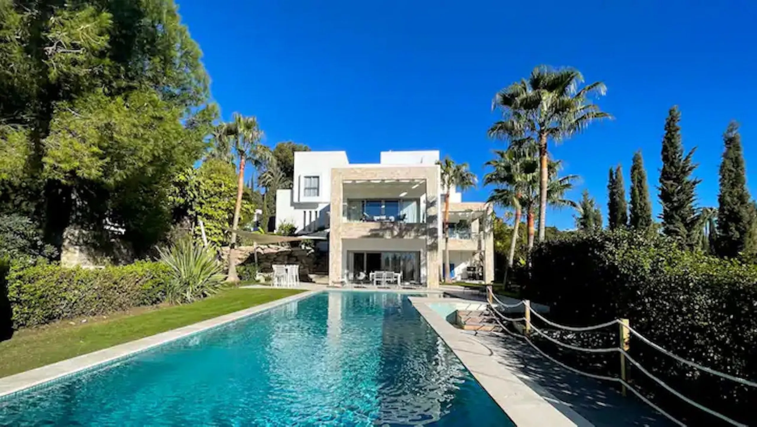 This magnificent villa is an open plan one, and the ground floor flows into the terrace and the garden with lovely sea views and a vast infinity pool, leading to a chill-out area with a fireplace. The villa has ensuite bedrooms on each floor, which gives 