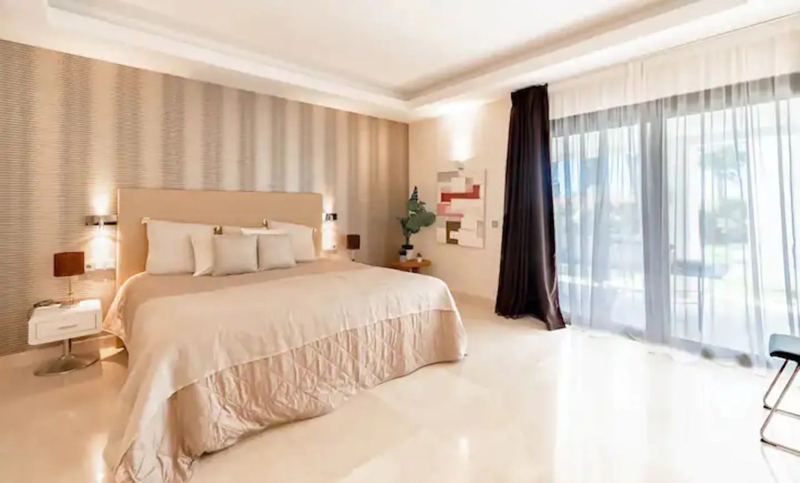 This magnificent villa is an open plan one, and the ground floor flows into the terrace and the garden with lovely sea views and a vast infinity pool, leading to a chill-out area with a fireplace. The villa has ensuite bedrooms on each floor, which gives 